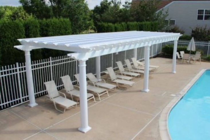 Freestanding Vinyl Patio Pergola by Backyard Pool with Lounge Chairs