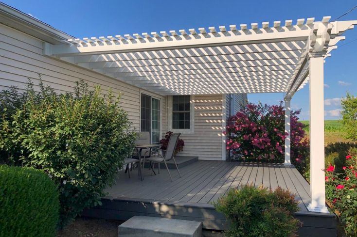 Backyard composite deck and vinyl homemade pergola assembled 