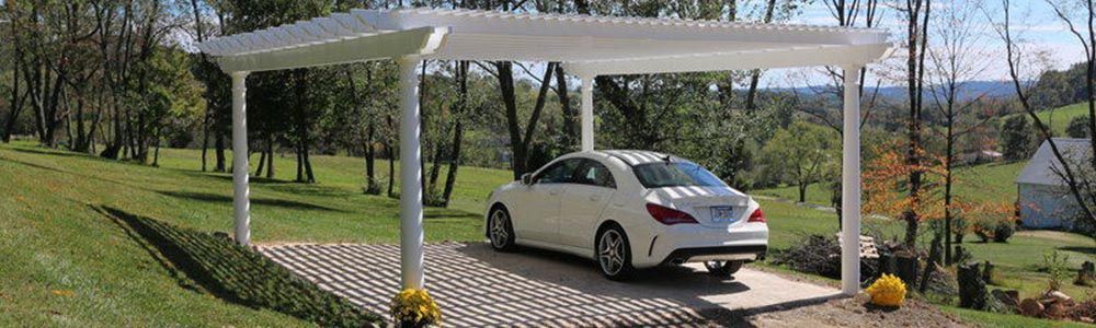 white custom-made pergola used as carport in yard