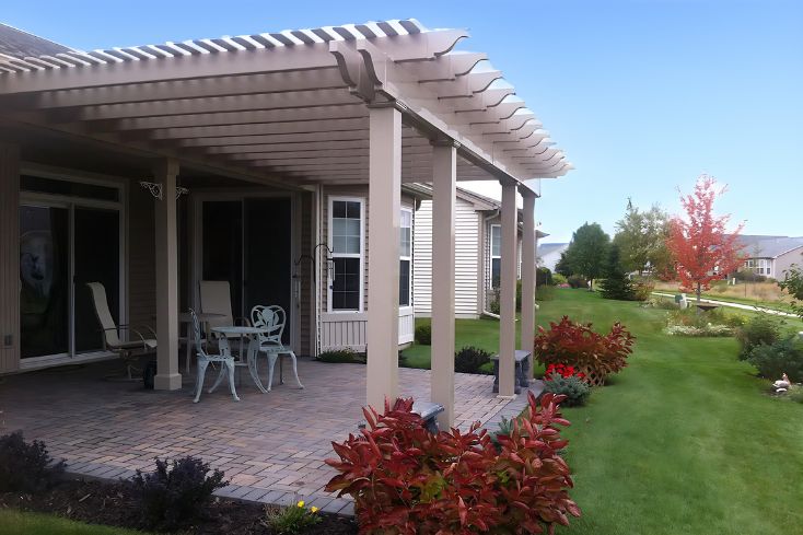 chairs under tan 16x16 pergola kit garden spot under blue sky